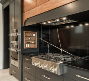 An upclose photo of the over range and black cabinets